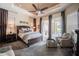Tranquil main bedroom with a tray ceiling, a ceiling fan, and patio access to the outdoor living space at 2026 Indian Sky Cir, Lakeland, FL 33813