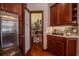 Well-stocked pantry with custom shelving and a decorative glass door is easily accessed from the gourmet kitchen at 2026 Indian Sky Cir, Lakeland, FL 33813