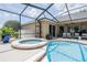 Beautiful screened-in pool and spa with elegant landscaping and plenty of space to relax at 2026 Indian Sky Cir, Lakeland, FL 33813
