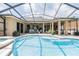 Spacious screened-in pool area with ample seating, a pristine pool, and covered patio at 2026 Indian Sky Cir, Lakeland, FL 33813