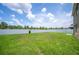 View of a green backyard with a white fence and a tree at 2062 Blue Highlands Dr, Lakeland, FL 33811