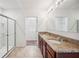 Bathroom boasts double sinks with granite countertops, tiled floors, and glass shower at 2062 Blue Highlands Dr, Lakeland, FL 33811