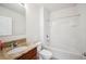 Bright bathroom featuring a granite countertop, wood vanity and bathtub with white tiled walls at 2062 Blue Highlands Dr, Lakeland, FL 33811