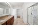 Bathroom with double sinks with granite countertops, tiled floors, and glass shower stall at 2062 Blue Highlands Dr, Lakeland, FL 33811