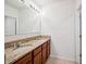 Bathroom featuring double sink vanity with granite counters, tiled floors, and large mirror at 2062 Blue Highlands Dr, Lakeland, FL 33811