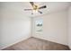 Bright bedroom features neutral carpet, ceiling fan, and window letting in natural light at 2062 Blue Highlands Dr, Lakeland, FL 33811