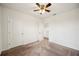 Spacious bedroom with neutral carpet, ceiling fan, and access to other rooms at 2062 Blue Highlands Dr, Lakeland, FL 33811