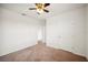 Carpeted bedroom with ceiling fan, neutral colored walls, and multiple doors at 2062 Blue Highlands Dr, Lakeland, FL 33811