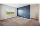 Carpeted bedroom features a patterned blue accent wall and a window with natural light at 2062 Blue Highlands Dr, Lakeland, FL 33811
