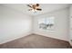 An empty bedroom with carpet, a ceiling fan, and a window at 2062 Blue Highlands Dr, Lakeland, FL 33811