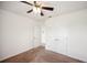 Spacious bedroom with neutral carpet, ceiling fan, and double door closet for storage at 2062 Blue Highlands Dr, Lakeland, FL 33811