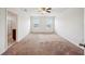 Open bedroom with neutral carpet, two windows and walk through access to bathroom at 2062 Blue Highlands Dr, Lakeland, FL 33811
