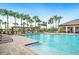 Stunning community pool surrounded by palm trees, sun loungers, and a pergola, ideal for resort-style living at 2062 Blue Highlands Dr, Lakeland, FL 33811