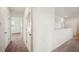 Upstairs hallway with carpet and white walls leading to bedrooms and loft area at 2062 Blue Highlands Dr, Lakeland, FL 33811