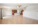 Spacious living room with tile flooring, connecting seamlessly to the modern kitchen and staircase at 2062 Blue Highlands Dr, Lakeland, FL 33811
