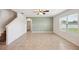 Open floorplan living room features stylish green accent wall, tile floors, and a ceiling fan at 2062 Blue Highlands Dr, Lakeland, FL 33811