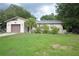 Single story home with attached garage, small palm tree and green lawn at 240 Lake Thomas Dr, Winter Haven, FL 33880