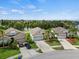 Aerial view of homes and neighborhood, showcasing landscaping, lake, and three-car driveways at 2544 Ladoga Dr, Lakeland, FL 33805