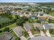 Aerial view of the neighborhood showcasing the lake, community features, and surrounding areas at 2544 Ladoga Dr, Lakeland, FL 33805