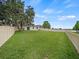 Large fenced backyard with lush green grass and mature trees offers ample space at 2544 Ladoga Dr, Lakeland, FL 33805