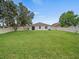 Large backyard with healthy lawn and privacy fence, ideal for recreation at 2544 Ladoga Dr, Lakeland, FL 33805