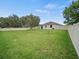 Vast, private backyard with a white fence, lush lawn, and space for recreation at 2544 Ladoga Dr, Lakeland, FL 33805