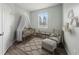 Charming Bedroom with a crib, rocking chair, soft rug, and a window allowing natural light at 2544 Ladoga Dr, Lakeland, FL 33805