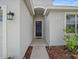 Inviting front entrance featuring a stylish door and manicured landscaping with wood mulch at 2544 Ladoga Dr, Lakeland, FL 33805