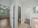 Hallway with tile flooring, leading to the bedroom, bathroom, and walk-in closet at 2544 Ladoga Dr, Lakeland, FL 33805