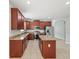 Well-lit kitchen featuring cherry-stained cabinetry, granite counters, and stainless steel appliances at 2544 Ladoga Dr, Lakeland, FL 33805