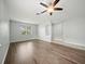 Open living room featuring wood-look floors and ample natural light from several windows at 2544 Ladoga Dr, Lakeland, FL 33805