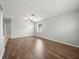 Bright, open living room with sleek flooring, a contemporary ceiling fan, and neutral wall paint at 2544 Ladoga Dr, Lakeland, FL 33805