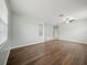 Spacious living room with laminate floors, a modern ceiling fan, and an open layout for entertaining at 2544 Ladoga Dr, Lakeland, FL 33805