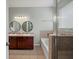 Well-lit main bathroom with double sinks, a bathtub, and modern fixtures at 2544 Ladoga Dr, Lakeland, FL 33805