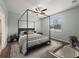 Elegant main bedroom featuring a four-poster bed, modern décor, and a large window at 2544 Ladoga Dr, Lakeland, FL 33805