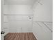 Spacious walk-in closet with ample shelving and laminate floors for efficient storage solutions at 2544 Ladoga Dr, Lakeland, FL 33805