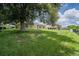 Lush backyard with mature tree and manicured lawn, creating a serene outdoor space for relaxation and recreation at 2714 Highlands Vue Pkwy, Lakeland, FL 33813
