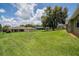 Expansive backyard with lush lawn and mature trees, offering privacy and a picturesque view in a desirable neighborhood at 2714 Highlands Vue Pkwy, Lakeland, FL 33813