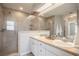 Bright bathroom featuring a glass-enclosed shower, double vanity, and ample mirror space for a luxurious experience at 2714 Highlands Vue Pkwy, Lakeland, FL 33813