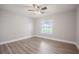 Well-lit bedroom features wood-look flooring and a ceiling fan at 2714 Highlands Vue Pkwy, Lakeland, FL 33813