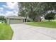 Charming home with an inviting driveway and a well-manicured front lawn, enhanced by mature trees and lush greenery at 2714 Highlands Vue Pkwy, Lakeland, FL 33813