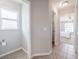 Bright hallway with tile floors, leading to a bedroom and half bath at 2714 Highlands Vue Pkwy, Lakeland, FL 33813