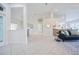 Bright and airy living room with white tile flooring and high ceilings, creating a modern and inviting living space at 2714 Highlands Vue Pkwy, Lakeland, FL 33813