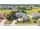 A beautiful single-story home featuring mature landscaping, a brick driveway, and a cozy front porch at 2817 High Winds Ln, Lakeland, FL 33813