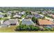 Wide aerial view of home in a community with lush landscaping and mature trees at 2817 High Winds Ln, Lakeland, FL 33813