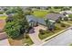 Aerial view of a beautifully landscaped home with a long driveway and lush greenery at 2817 High Winds Ln, Lakeland, FL 33813