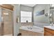 Bathroom showcases a large soaking tub, tiled surround, and a glass enclosed shower at 2817 High Winds Ln, Lakeland, FL 33813