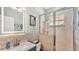 Modern bathroom featuring a glass-enclosed shower and an illuminated vanity mirror at 2817 High Winds Ln, Lakeland, FL 33813