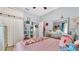 Comfortable bedroom featuring a pink comforter, decorative accents, and ceiling fan at 2817 High Winds Ln, Lakeland, FL 33813