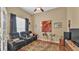 Cozy bonus room features comfortable recliners, a ceiling fan, and natural light at 2817 High Winds Ln, Lakeland, FL 33813